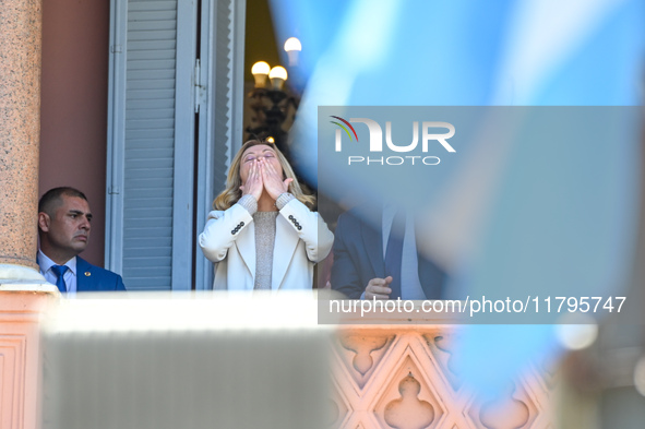 Italian Prime Minister Giorgia Meloni and Argentinian President Javier Milei greet from the balcony of the Argentine Government House in Bue...