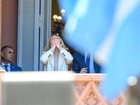 Italian Prime Minister Giorgia Meloni and Argentinian President Javier Milei greet from the balcony of the Argentine Government House in Bue...