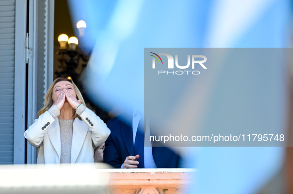 Italian Prime Minister Giorgia Meloni and Argentinian President Javier Milei greet from the balcony of the Argentine Government House in Bue...