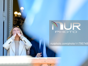 Italian Prime Minister Giorgia Meloni and Argentinian President Javier Milei greet from the balcony of the Argentine Government House in Bue...