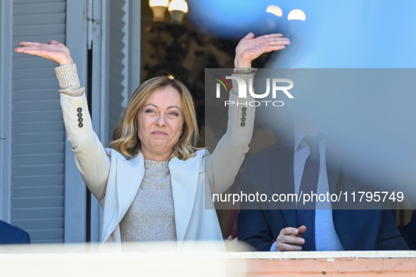 Italian Prime Minister Giorgia Meloni and Argentinian President Javier Milei greet from the balcony of the Argentine Government House in Bue...