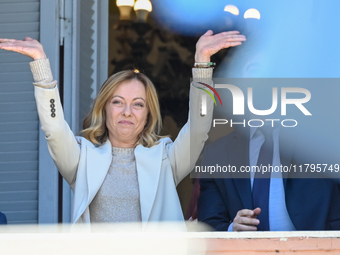 Italian Prime Minister Giorgia Meloni and Argentinian President Javier Milei greet from the balcony of the Argentine Government House in Bue...