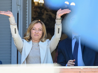 Italian Prime Minister Giorgia Meloni and Argentinian President Javier Milei greet from the balcony of the Argentine Government House in Bue...