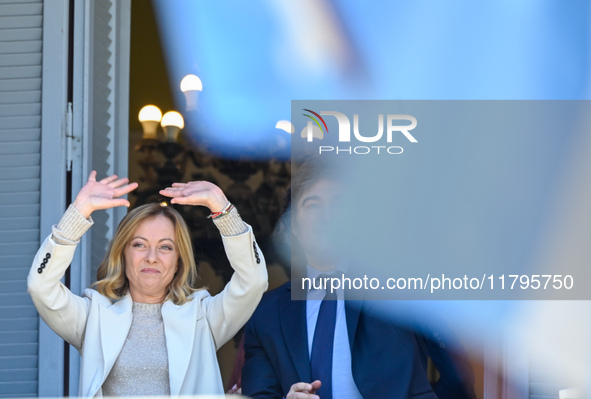 Italian Prime Minister Giorgia Meloni and Argentinian President Javier Milei greet from the balcony of the Argentine Government House in Bue...