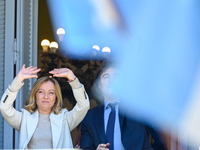 Italian Prime Minister Giorgia Meloni and Argentinian President Javier Milei greet from the balcony of the Argentine Government House in Bue...