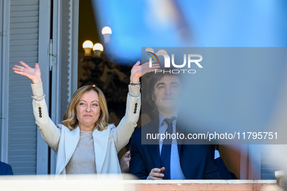 Italian Prime Minister Giorgia Meloni and Argentinian President Javier Milei greet from the balcony of the Argentine Government House in Bue...