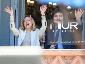 Italian Prime Minister Giorgia Meloni and Argentinian President Javier Milei greet from the balcony of the Argentine Government House in Bue...