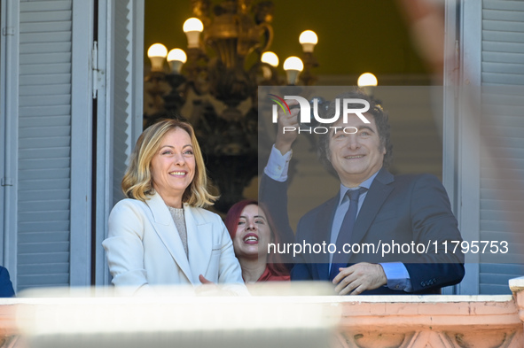 Italian Prime Minister Giorgia Meloni and Argentinian President Javier Milei greet from the balcony of the Argentine Government House in Bue...