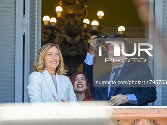 Italian Prime Minister Giorgia Meloni and Argentinian President Javier Milei greet from the balcony of the Argentine Government House in Bue...