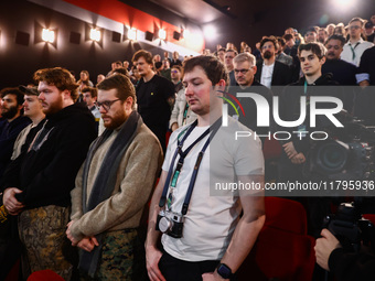 The audience stands in a minute of silence before the world premiere of  'Rust' film during the 32nd International Film Festival Energa CAME...