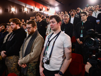 The audience stands in a minute of silence before the world premiere of  'Rust' film during the 32nd International Film Festival Energa CAME...