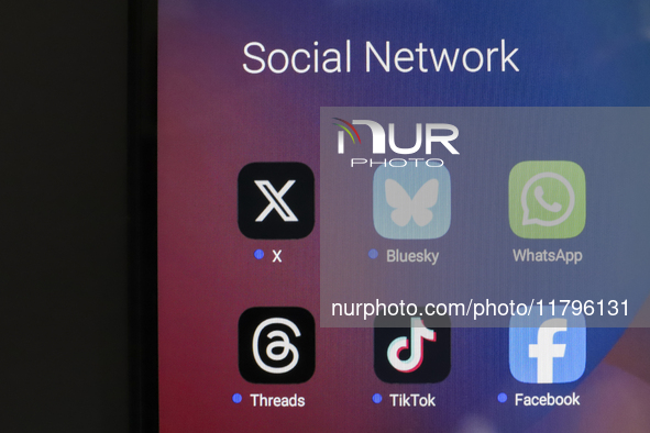 The logos of the social networks X (Twitter), Bluesky, WhatsApp, Threads, TikTok, and Facebook are displayed on the screen of a smartphone i...
