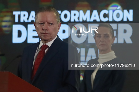 Mexico's President Claudia Sheinbaum Pardo is seen in the background while Arturo Zaldivar Lelo de Larrea, Coordinator of Policy and Governm...