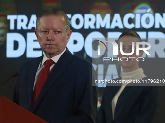 Mexico's President Claudia Sheinbaum Pardo is seen in the background while Arturo Zaldivar Lelo de Larrea, Coordinator of Policy and Governm...