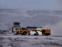 A snowplow clears the landing strip at the airfield in the town of Husavik, Iceland, on November 19, 2024. (