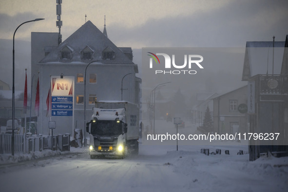 A truck moves along one of the main streets in Husavik, Iceland, on November 19, 2024. 