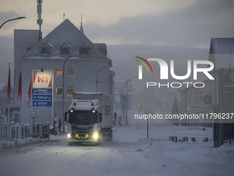 A truck moves along one of the main streets in Husavik, Iceland, on November 19, 2024. (