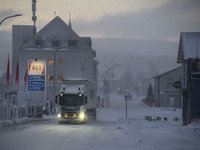 A truck moves along one of the main streets in Husavik, Iceland, on November 19, 2024. (