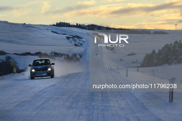 A car drives on one of the roads around the town of Husavik, Iceland, on November 19, 2024. 