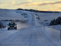 A car drives on one of the roads around the town of Husavik, Iceland, on November 19, 2024. (