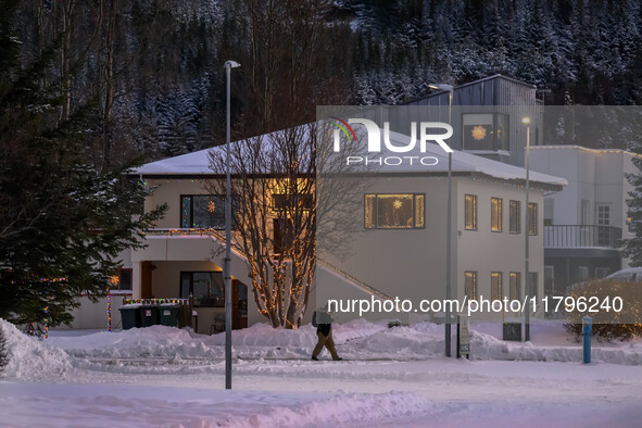 A person walks down a street in the town of Husavik, Iceland, on November 19, 2024. 