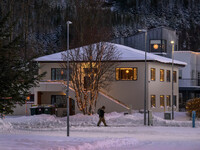 A person walks down a street in the town of Husavik, Iceland, on November 19, 2024. (