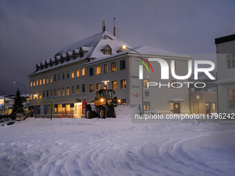 A snowplow cleans the streets in the town of Husavik, Iceland, on November 19, 2024. (