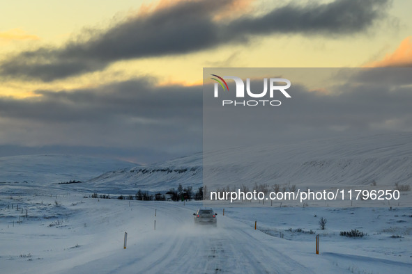 A car drives on one of the roads around the town of Husavik, Iceland, on November 19, 2024. 