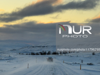 A car drives on one of the roads around the town of Husavik, Iceland, on November 19, 2024. (