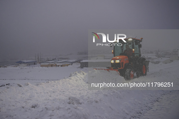 A snowplow cleans the streets in the town of Husavik, Iceland, on November 19, 2024. 