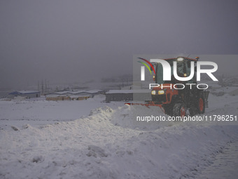 A snowplow cleans the streets in the town of Husavik, Iceland, on November 19, 2024. (