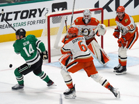 Jamie Benn #14 of the Dallas Stars and Brian Dumoulin #6 of the Anaheim Ducks battle for the puck during the NHL regular season match at the...