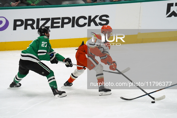 Trevor Zegras #11 of the Anaheim Ducks skates on the ice with the puck against the Dallas Stars during the NHL regular season match at the A...