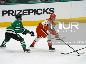 Trevor Zegras #11 of the Anaheim Ducks skates on the ice with the puck against the Dallas Stars during the NHL regular season match at the A...