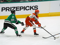 Trevor Zegras #11 of the Anaheim Ducks skates on the ice with the puck against the Dallas Stars during the NHL regular season match at the A...