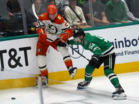 Wyatt Johnston #53 of the Dallas Stars and Jackson LaCombe #2 of the Anaheim Ducks battle for the puck during the NHL regular season match a...