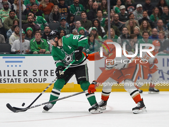 Tyler Seguin #91 of the Dallas Stars and Brett Leason #20 of the Anaheim Ducks battle for the puck during the NHL regular season match at th...