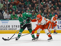 Tyler Seguin #91 of the Dallas Stars and Brett Leason #20 of the Anaheim Ducks battle for the puck during the NHL regular season match at th...