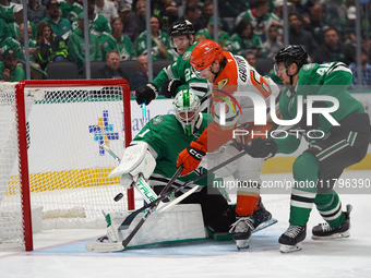 Cutter Gauthier #61 of the Anaheim Ducks puts the puck in the goal against goalie Casey DeSmith #1 of the Dallas Stars during the NHL regula...