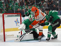 Cutter Gauthier #61 of the Anaheim Ducks puts the puck in the goal against goalie Casey DeSmith #1 of the Dallas Stars during the NHL regula...