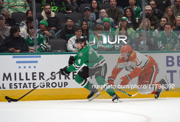 Miro Heiskanen #4 of the Dallas Stars and Leo Carlsson of the Anaheim Ducks battle for the puck during the NHL regular season match at the A...