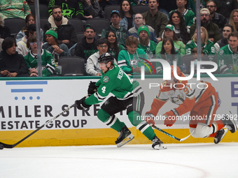 Miro Heiskanen #4 of the Dallas Stars and Leo Carlsson of the Anaheim Ducks battle for the puck during the NHL regular season match at the A...