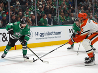 Sam Steel #18 of the Dallas Stars competes for the puck against Brian Dumoulin #6 of the Anaheim Ducks during the NHL regular season match a...