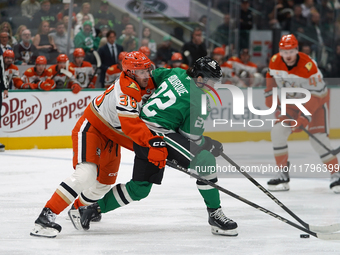 Jansen Harkins #38 of the Anaheim Ducks tries to get the puck from Mavrik Bourque #22 of the Dallas Stars during the NHL regular season matc...