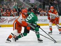 Jansen Harkins #38 of the Anaheim Ducks tries to get the puck from Mavrik Bourque #22 of the Dallas Stars during the NHL regular season matc...