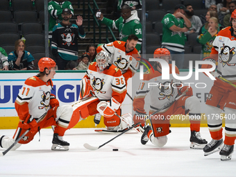 Anaheim Ducks players are on the ice against the Dallas Stars during the NHL regular season match at the American Airlines Center in Dallas,...