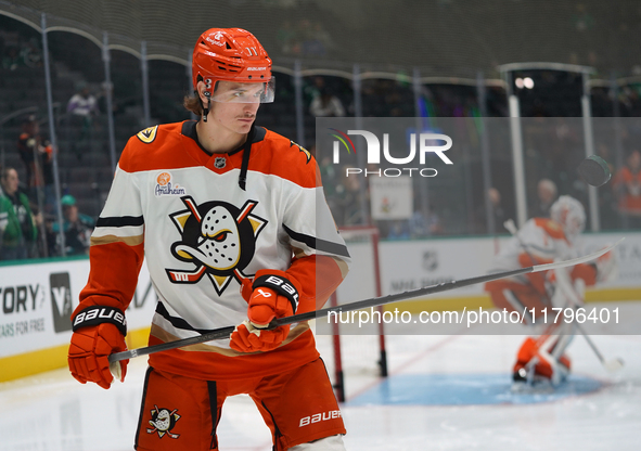 Trevor Zegras #11 of the Anaheim Ducks plays with the puck against the Dallas Stars during the NHL regular season match at the American Airl...