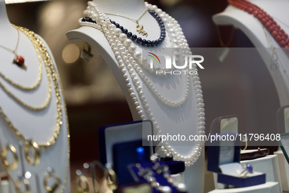 Jewelry is displayed in a store window on the street in Krakow, Poland, on November 18, 2024. 