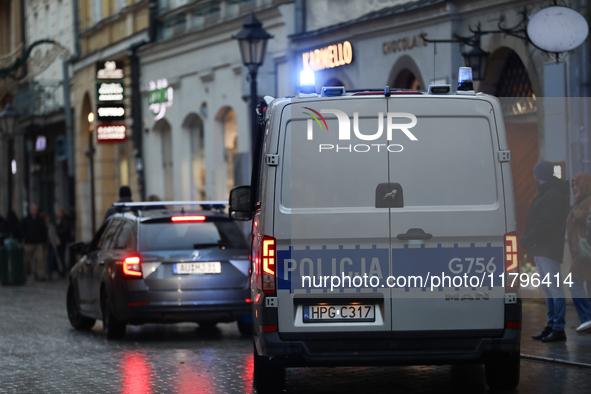 Police stop a car on the street in Krakow, Poland, on November 18, 2024. 