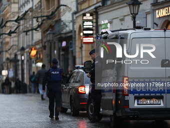 Police stop a car on the street in Krakow, Poland, on November 18, 2024. (